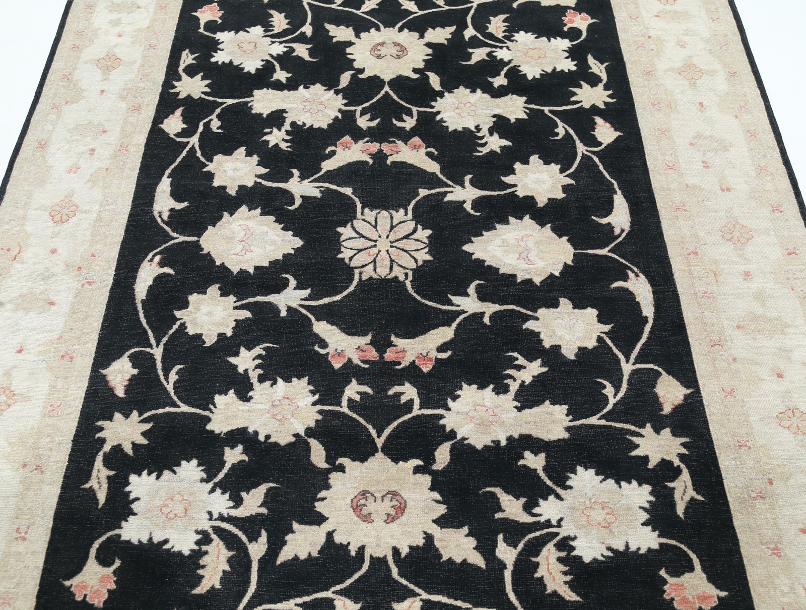 5.7×8 ft Hand Knotted Floral Area Rug with Black Field and Beige Border