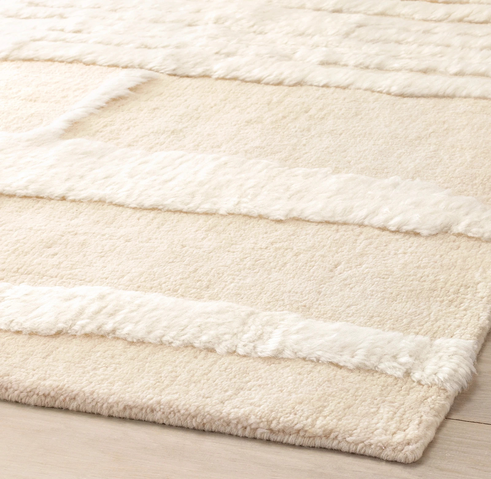 knotted by hand, then carved into intersecting lines of luxe pile with high-low